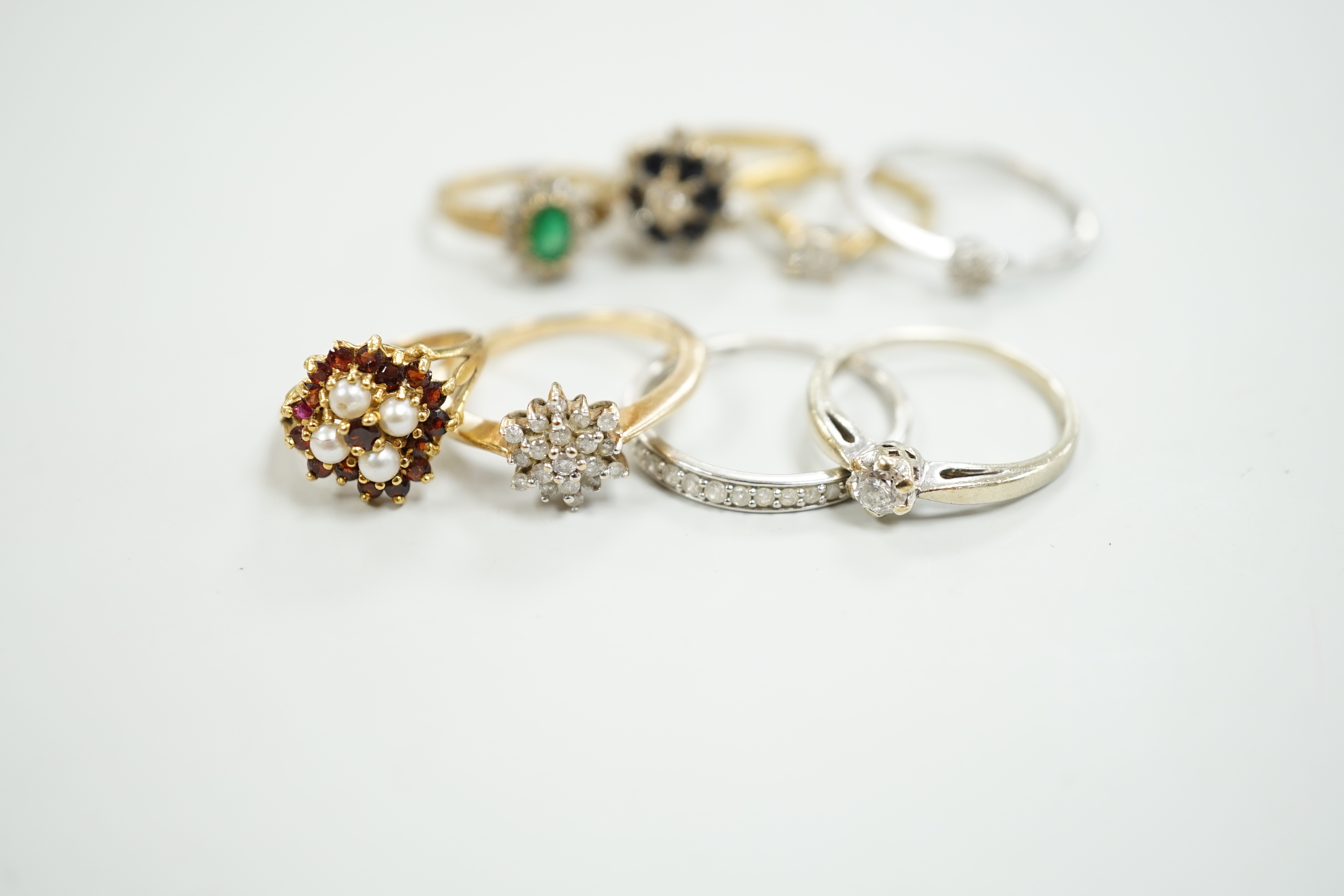 Eight assorted mainly modern 9ct gold and gem set rings, including solitaire diamond and diamond chip half eternity, gross weight 18.8 grams.